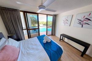 a bedroom with a bed with a view of a pool at Gemini Resort, 2bedroom Unit19 and carpark Golden Beach, Caloundra in Golden Beach +26 photos