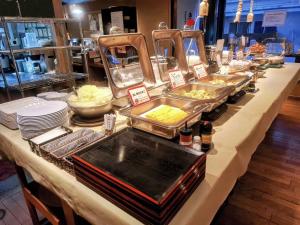 a buffet of food on a table in a store at Hotel Roco Inn Okinawa in Naha