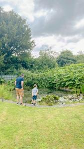 a man and a boy are looking at a stream at The Old Coach House at Stewton in Louth