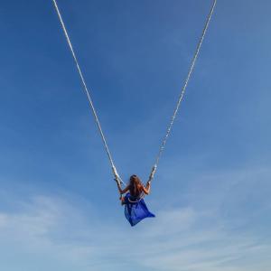 a girl in a blue dress on a swing at Palawan Swing in Puerto Princesa City