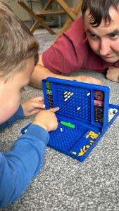 a man and a boy playing with a toy laptop at The Old Coach House at Stewton in Louth