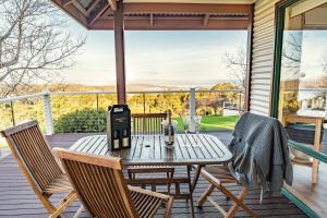 a patio with a table and chairs on a deck at Karri Mia Chalets and Studios in Denmark