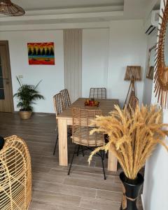 a dining room with a wooden table and chairs at Appartement Emeraude zone 4 in Abidjan