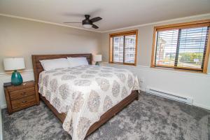 a bedroom with a bed and two windows at ML316 Stylish Modern Breathtaking Mtn And Trail View EZ Parking in Snowshoe +4 photos