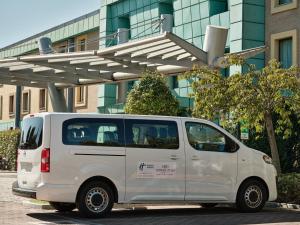 a white van parked in front of a building at Crowne Plaza Milan - Malpensa Airport by IHG in Case Nuove