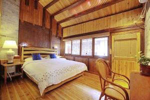 a bedroom with a bed and a table and chairs at Governor's Mansion in Yangshuo