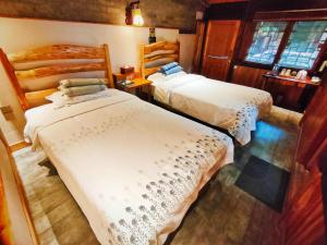 a bedroom with two beds and a window at Governor's Mansion in Yangshuo +63 photos