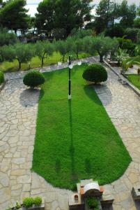 an overhead view of a park with a clock in the grass at Elia Apartments Sithonia in Elia