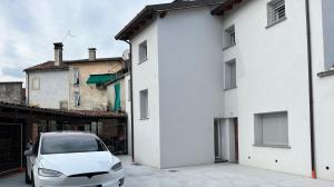 a white car parked next to a white building at B&B da Mimì in San Vito al Tagliamento