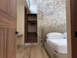 a bedroom with a bed and a wall at Villa Escondida - Riviera Maya in Puerto Morelos +31 photos