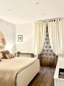 a bedroom with a bed and a window at Scipioni Relais in Rome