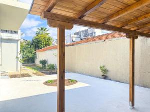a patio with a wooden pergola at Cityscape Residence with a Patio in Volos