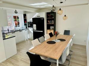a kitchen with a wooden table and white cabinets at LaVerde - Blisko Przyrody Daleko od Tłumu in Skomielna Czarna