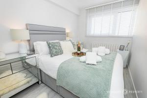 a bedroom with a bed with towels on it at Seaview Retreat by Grandeur Property in Southbourne