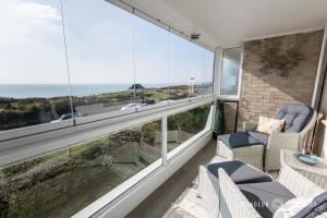 a balcony with a view of the ocean at Seaview Retreat by Grandeur Property in Southbourne