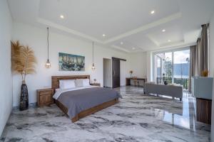 a bedroom with a large bed and a large window at Adara Lake View Residence Bedugul - Bali in Bedugul