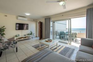 a living room with a view of the ocean at Coastal Nest in Durban North