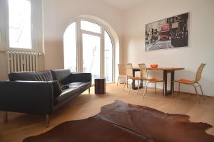 a living room with a couch and a table at Wohnen am Kulturspeicher mit eigenem Parkplatz in Würzburg