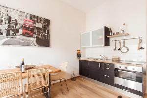 a kitchen with a table and a dining room at Wohnen am Kulturspeicher mit eigenem Parkplatz in Würzburg