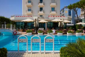 a swimming pool in front of a hotel at Ruhl Beach Hotel & Suites in Lido di Jesolo