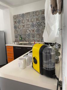 a yellow and black toaster sitting on a kitchen counter at MareSol in Marsala +12 photos