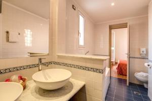 a white bathroom with a sink and a toilet at Hotel San Remo in Rome +37 photos