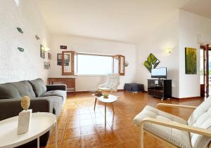 a living room with a couch and a table at Solemar Sicilia - Ville Paradiso in Santa Flavia