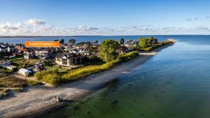 an aerial view of a town next to the water at Bursztynowa Rewa, Sun & Snow in Rewa