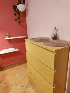a bathroom with a yellow dresser and red wall at Casa-Chalet Anabel in El Puerto de Santa María +47 photos