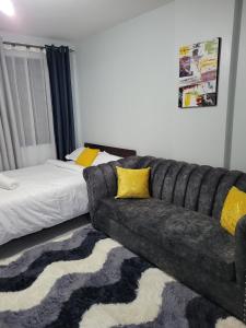 a living room with a couch and a bed at VIVI GRAY ,Muthiga, Waiyaki Way in Nairobi