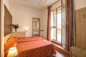 a hotel room with a bed and a window at Hotel San Remo in Rome