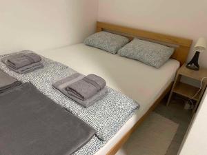 a bedroom with two twin beds with towels on them at Apartman Djokic 3 in Požarevac