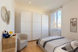 a bedroom with a bed and a chair at Nice Flat Milan 50m Station! in Milan