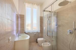 a bathroom with a sink and a toilet and a shower at Nice Flat Milan 50m Station! in Milan