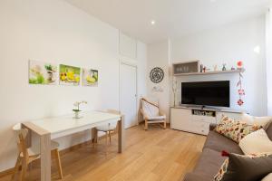 a living room with a table and a couch at Nice Flat Milan 50m Station! in Milan
