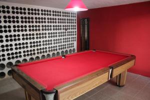 a red pool table in a room with a wall at Casa de Tapadeiro in Resende