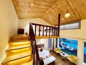 a room with a staircase and a bed in a house at Kasauli Pine Hill Cottages I Kasauli in Kasauli