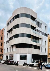 a large building with cars parked in front of it at Royal Suites in Las Palmas de Gran Canaria