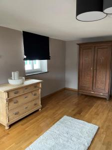 a living room with a dresser and a television at die Lecherei in Lechbruck