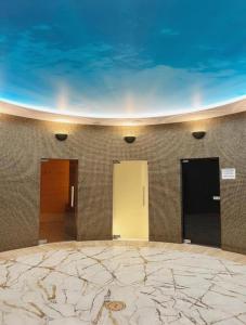 a room with three doors and a tile wall at Apartament Pobierowo PINEA in Pobierowo
