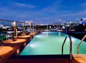 a swimming pool on the roof of a building at Q-White Crescent in Cochin