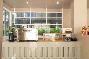 a kitchen with a counter with a fish tank and a window at Samyan Story Boutique Hotel in Bangkok