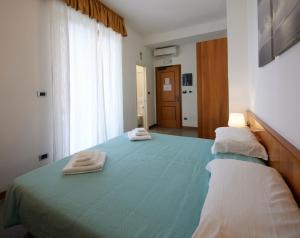 a bedroom with a bed with two towels on it at Hotel Villa Adriana in Monterosso al Mare