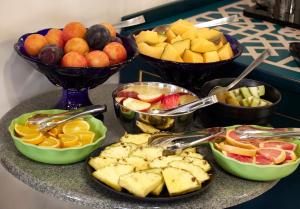 a table with bowls of fruit and plates of food at Hotel Villa Adriana in Monterosso al Mare