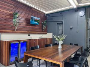 a dining room with a wooden table and chairs at Country in City Darling Harbour Retreat Pool in Sydney +43 photos