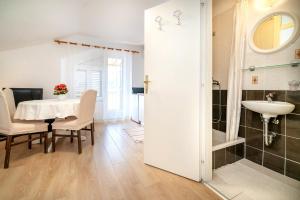 a dining room with a table and a sink at Studio Apartments Cavrak with Terrace in Baška +69 photos