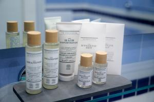 a group of four bottles of moisturizers on a table at Hotel Villa Adriana in Monterosso al Mare