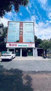 a building with a car parked in front of it at Hotel Kailas - Near MIDC Waluj in Waluj Buzurg