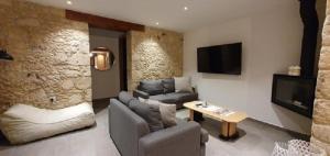 a living room with a couch and a tv at Villa Anthitsa in Paphos