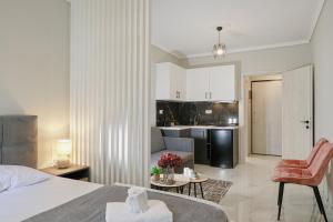 a hotel room with a bed and a kitchen at Olympia 1 in Xanthi